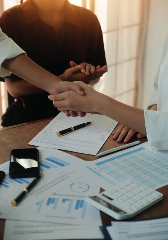 A handshake over a desk